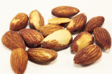 Selective focus almonds on white background.