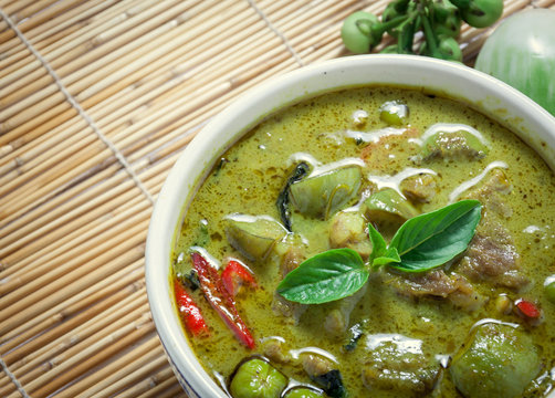 Thai food the pork green curry and eggplant on bamboo background