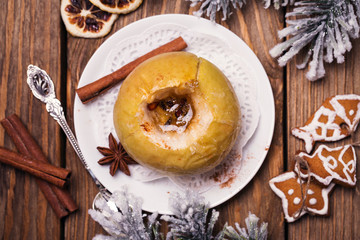 Top view of a baked apple with Christmas cookies