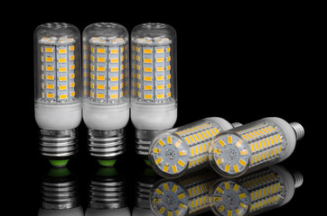 LED corn lamp on a black background with reflection