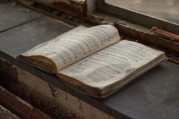 Old hymn book in a ruin - 96124004