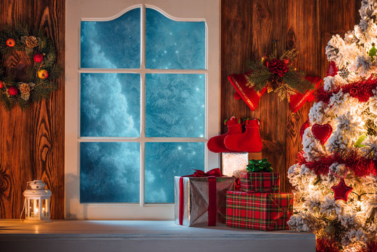 Christmas scene with tree gifts and frozen window in background
