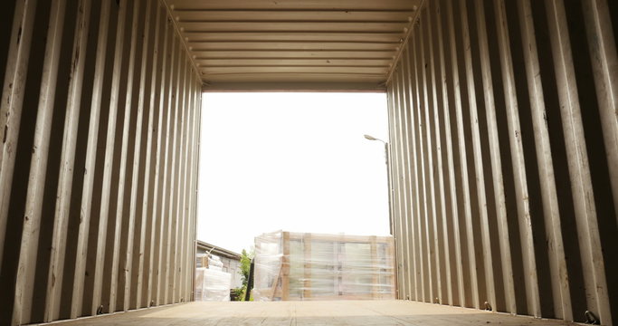 Forklift lifting up a cargo inside container view	