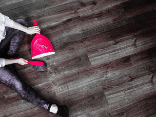 Cleaning woman sweeping wooden floor