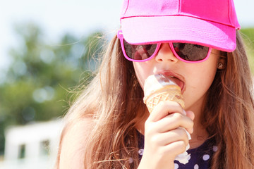 Little girl kid eating ice cream on beach. Summer.