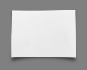 piece of ripped white paper on gray background