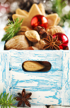 Christmas cookies, nuts and anise in wooden box.