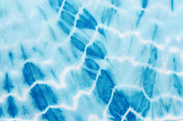 Abstract blue shapes pattern on fabric. Blue with white lines shapes pattern on material as background. Water like print on fabric.