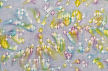 Abstract shape pattern on fabric. Colorful painted and stained material as background.