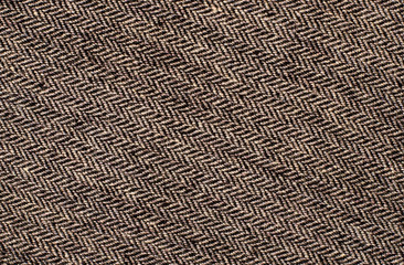 Close up on tweed knit woolen texture. Brown woven thread as a background. - obrazy, fototapety, plakaty