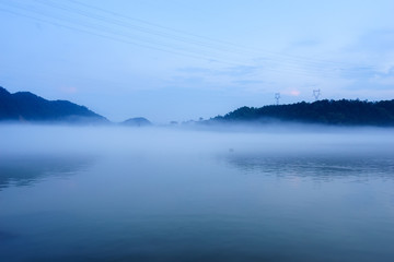 lake in fog in blue sky
