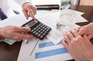 Real estate agent showing the purchase price to his client