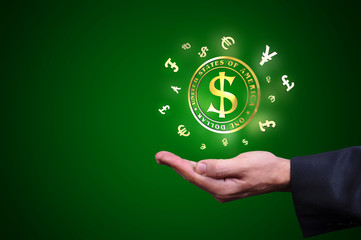 Currency gold symbols in a man hand