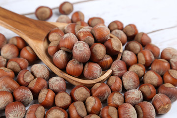 Hazelnuts in a wooden spoon