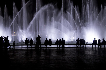 Silhouette of people watching dancing fountain in Ankara city in Turkey