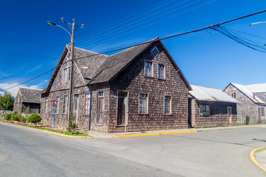 View of wooden houses lining streets of Curaco de Velez village, Quinchao island, Chile