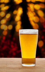 Glass of beer on wooden in bokeh