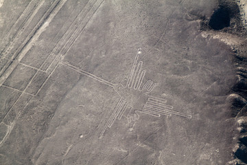 Aerial view of geoglyphs near Nazca - famous Nazca Lines, Peru. In the center, Hummingbird figure...