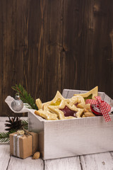 Silver gift box with homemade star shaped cookies. Xmas or new year card. Toned image. Selective focus