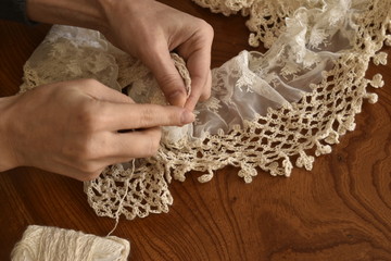 Women hand with knitting scarf
