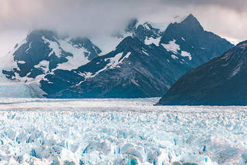 Perito Moreno Glacier lines the bottom of a mountain range - Argentina