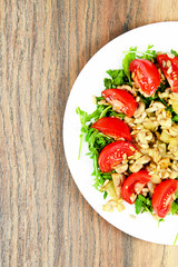 Salad with Tomatoes, Mushrooms, Arugula and Sunflower Seeds.