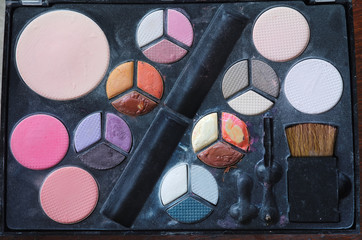 close up and Top View of dirty makeup brush and colorful cosmetics