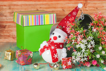 Christmas composition with small snowman and flower