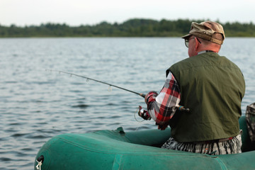 Spinning fisherman on a boat fishing