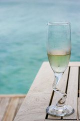 A champagne glasses by the ocean