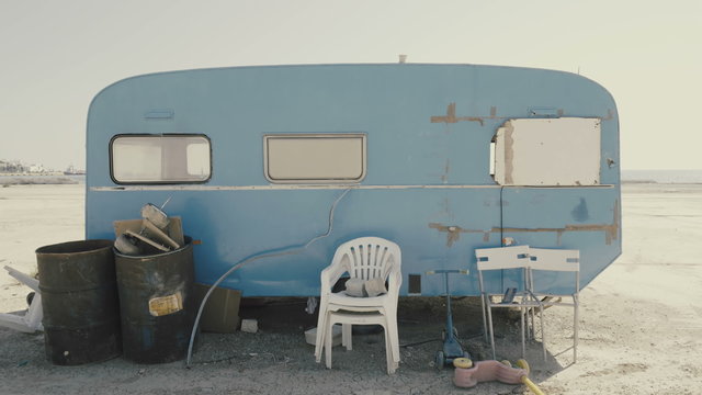 Rickety old vintage abandoned caravan/trailer in a deserted camp/area