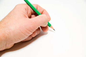 Men's left hand holding a pencil on over white
