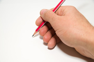 Men's right hand holding a pencil on over white