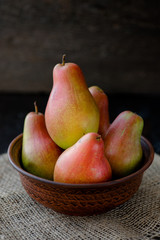 organic pears in the plate, on the wooden background
