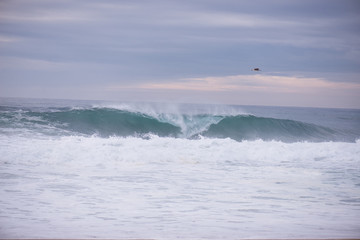 Wave crashing on a coast in Nazare, Portugal.