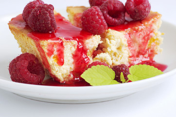 cake with raspberries and cream cheese decorated with fresh rasp