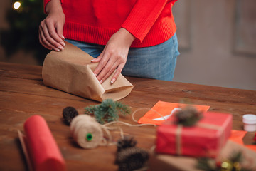 woman hands closeup wrapping gifts