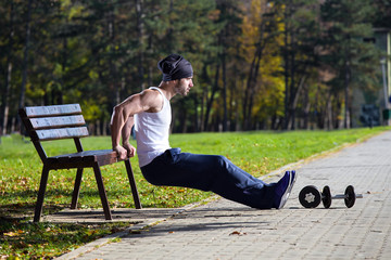 man exercise on street bench