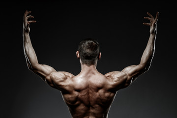 bodybuilder posing and turned his back