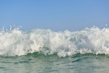 clean turquoise sea wave close up, soft focus