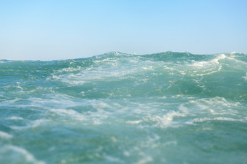 clean turquoise sea wave close up, soft focus
