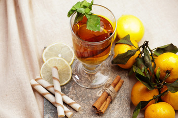 Tea with lemon, cinnamon sticks, tangerine