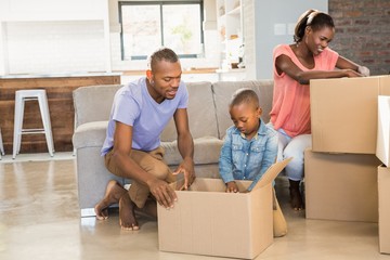 Family unwrapping things in new home