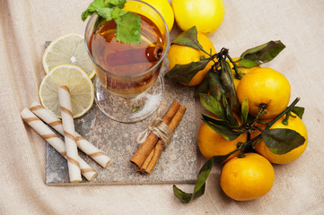 Tea with lemon, cinnamon sticks, tangerine