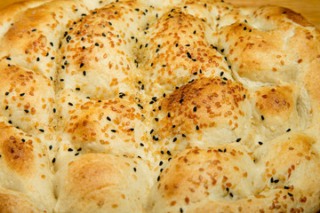Fragment of turkish bread with sesame seeds. Selective focus