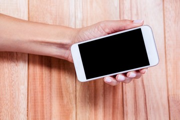 Feminine hand holding smartphone