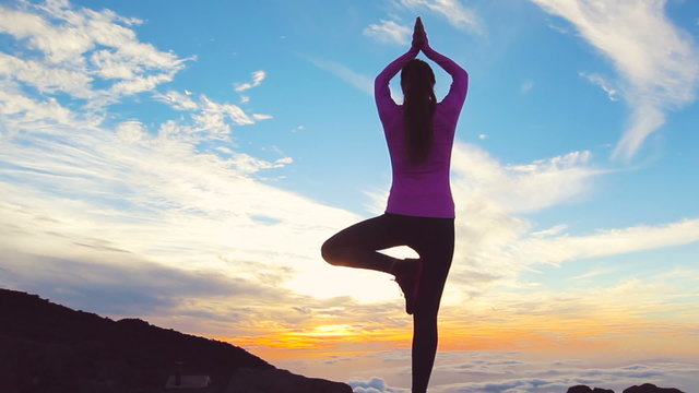 Young Woman Standing Yoga Pose on top of Mountain. Reaching the Top. Healthy Active Lifestyle. 