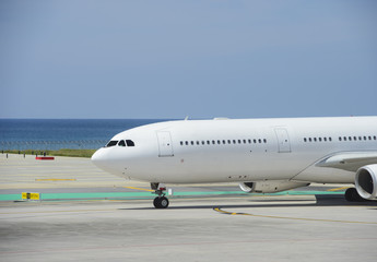 Commercial airplane taxiing on a seashore