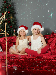 Girls as angels are waiting for Santa Claus 