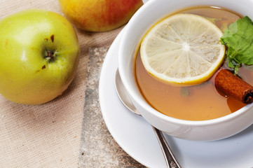 Tea with lemon, cinnamon sticks, tangerine